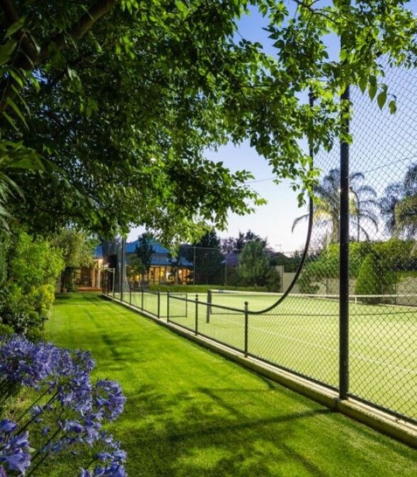 Tennis court included in a garden design. 